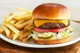 The Outbacker Burger at Outback Steakhouse – Bold, Smoky, and Unforgettable Flavor 2 The Outbacker Burger with beef patty, bacon, cheddar, lettuce, tomato, and BBQ sauce on a toasted bun